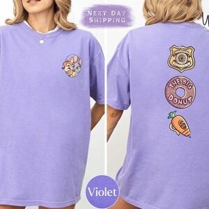 The image is a collage of two photos of a person wearing a purple t-shirt with various cartoon-style designs and text.