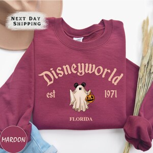 a purple shirt with a ghost and a pumpkin on it