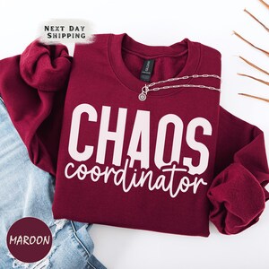 a red shirt that says chaos coordination on it