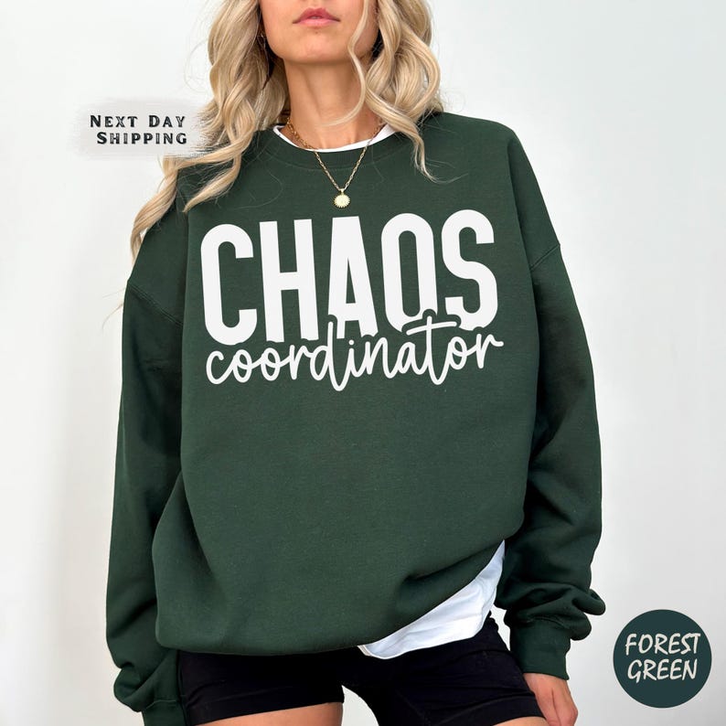 a woman wearing a green sweatshirt that says chaos coordination