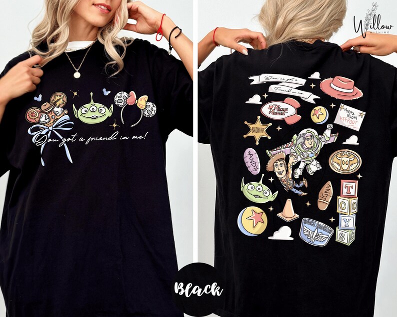 a woman wearing a black t-shirt with various cartoon characters and designs printed on it.