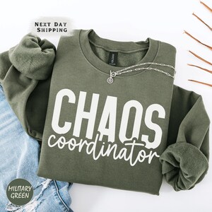 a green sweatshirt with the words chaos coordinates printed on it