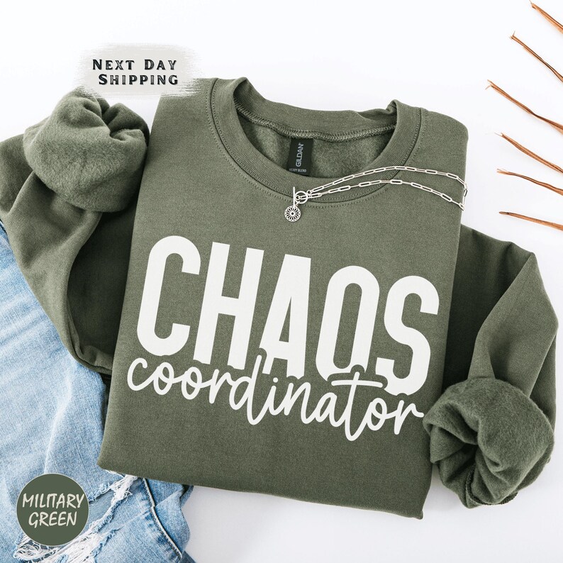 a green sweatshirt with the words chaos coordinates printed on it