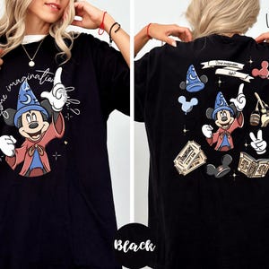 A woman wearing a black t-shirt with a graphic of Mickey Mouse and the text "Some imagination" printed on it.