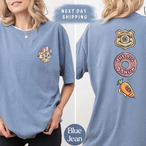 The image is a collage of two photos of a woman wearing a blue t-shirt with various cartoon-style logos and text. The woman is posing in front of a white background.