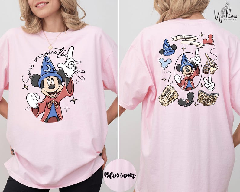 A woman wearing a pink t-shirt with a cartoon character and text printed on it.