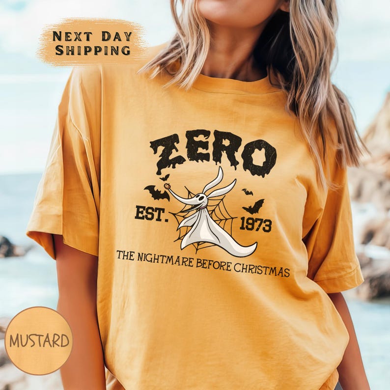 a woman wearing a yellow zero tshirt next to the ocean