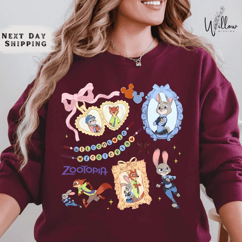 A woman wearing a burgundy sweatshirt with various cartoon animal characters and a mirror frame.