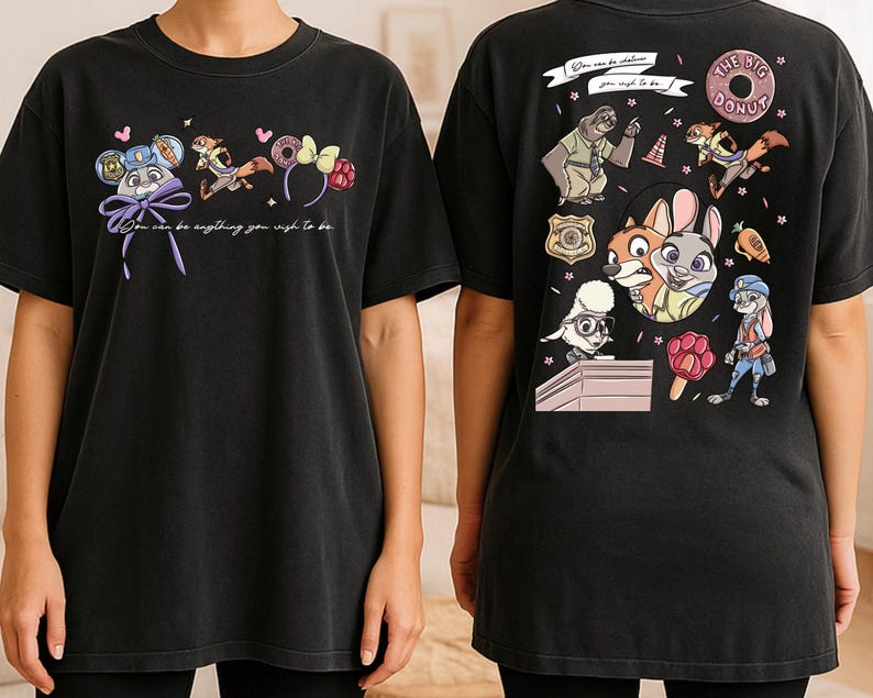 two black t-shirts with colorful cartoon characters and text printed on them.