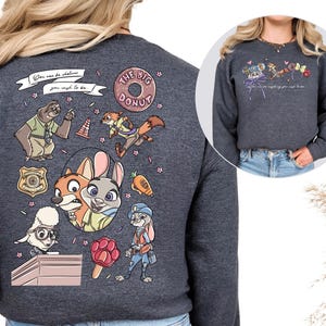 a gray sweatshirt with a colorful and whimsical design, including cartoon animal characters and various other elements.