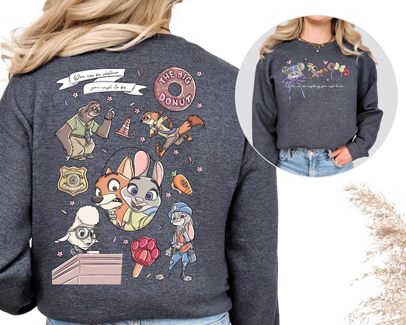 a gray sweatshirt with a colorful and whimsical design, including cartoon animal characters and various other elements.