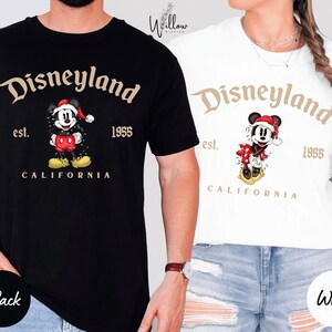 a man and a woman wearing Disneyland-themed t-shirts.