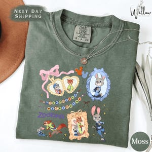 a green t-shirt with various cartoon animal characters and a heart-shaped ribbon design.