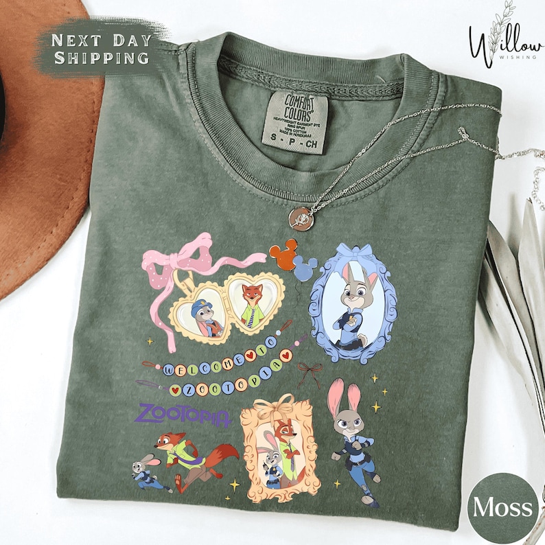 a green t-shirt with various cartoon animal characters and a heart-shaped ribbon design.