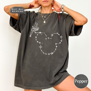 a woman wearing a black shirt with a heart drawn on it