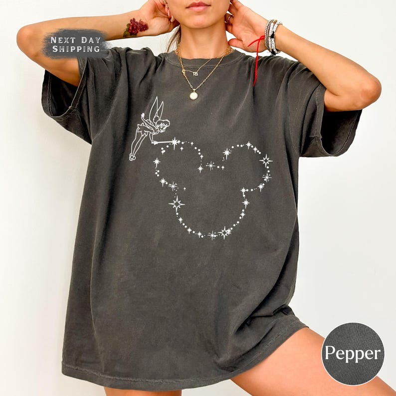 a woman wearing a black shirt with a heart drawn on it