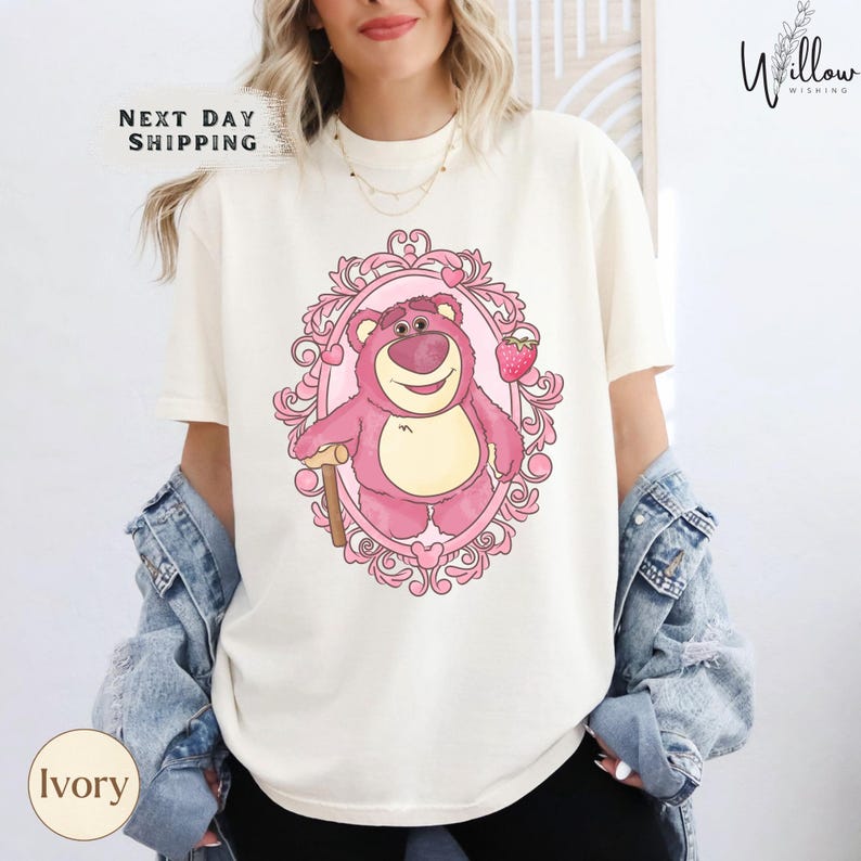a woman wearing a t - shirt with a cartoon character on it
