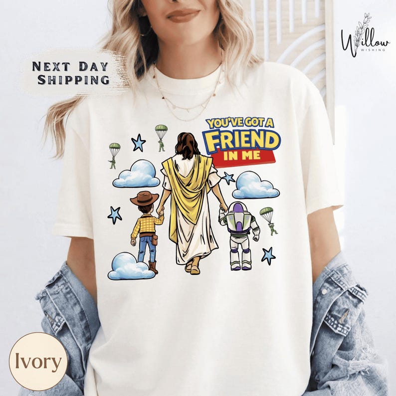 A woman wearing a white t-shirt with a graphic design depicting a cartoon character, a boy, and a robot, along with the text "You've got a FRIEND in me".