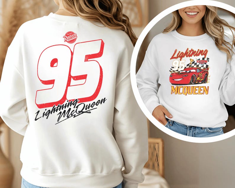 a woman wearing a white sweatshirt with a red and black design on the back.