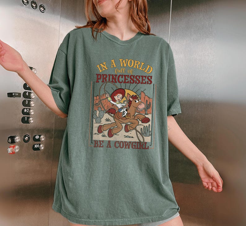 a woman in a green shirt standing in front of a metal wall