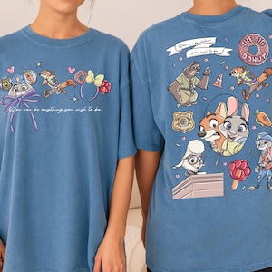 two blue t-shirts with cartoon characters and text printed on them.