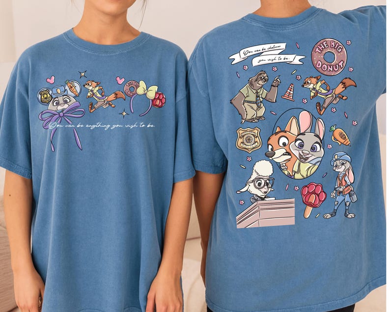 two blue t-shirts with cartoon characters and text printed on them.