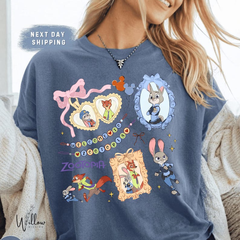 A woman wearing a blue t-shirt with various cartoon characters and designs, including a police officer character.