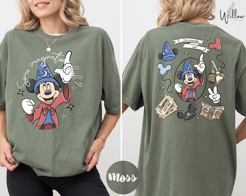 A woman wearing a green t-shirt with a graphic of Mickey Mouse and various Disney-themed elements.