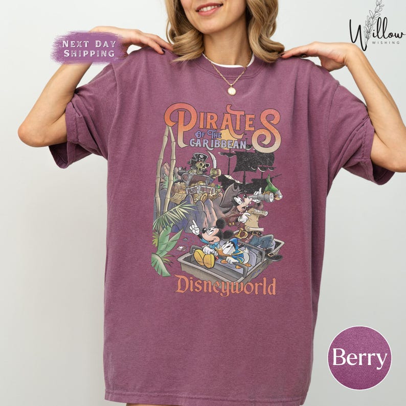 A woman wearing a purple t-shirt with a graphic of Disney characters from the Pirates of the Caribbean ride at Disneyworld.