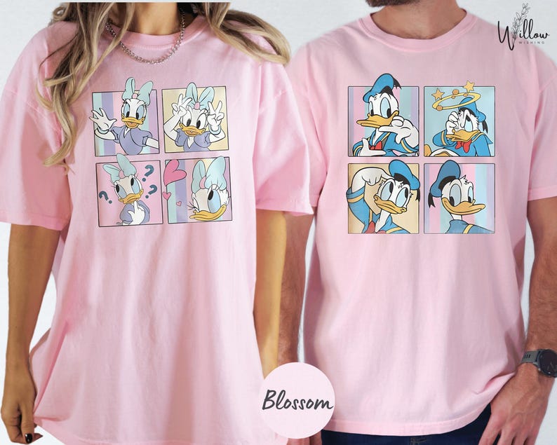 two people wearing pink t-shirts with a collage of cartoon duck images.