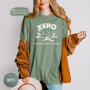 a woman wearing a green shirt and a hat