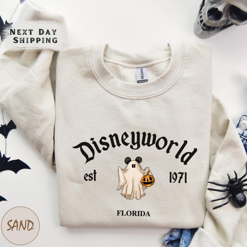 a white shirt with a mickey mouse and ghost on it