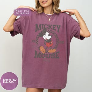 a woman wearing a mickey mouse t - shirt
