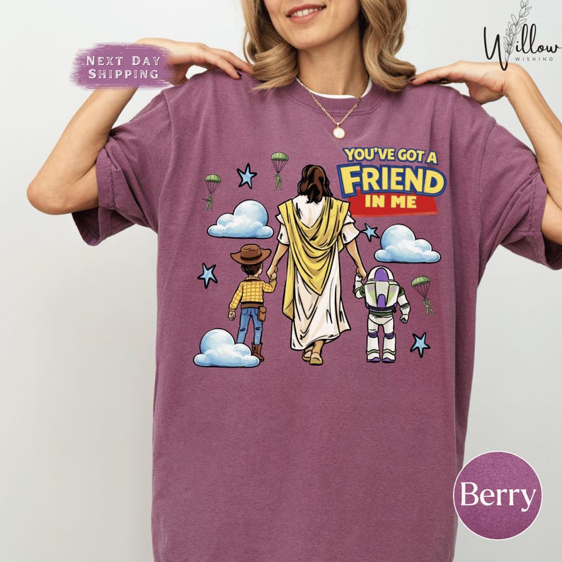 A woman wearing a purple t-shirt with a graphic design depicting a cartoon character, a young girl, and a man, along with the text "You've got a FRIEND in me".