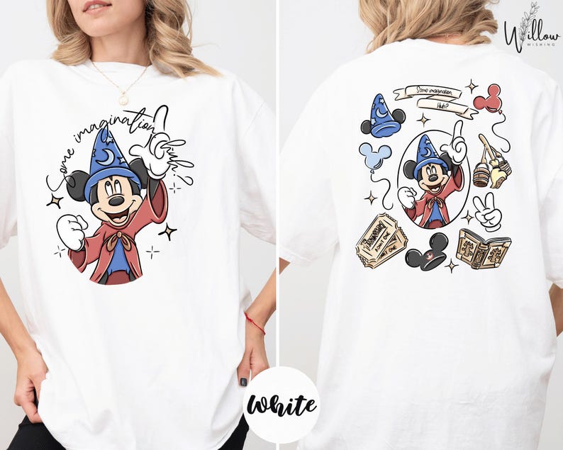 A white t-shirt with a graphic of Mickey Mouse and various Disney-themed elements, including a wizard hat, a magic wand, and a book.