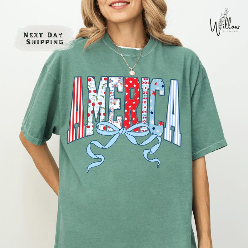 A woman wearing a green t-shirt with the word "AMERICA" printed on it.