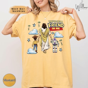 A woman wearing a yellow t-shirt with a graphic design depicting a cartoon character and a Bible verse.