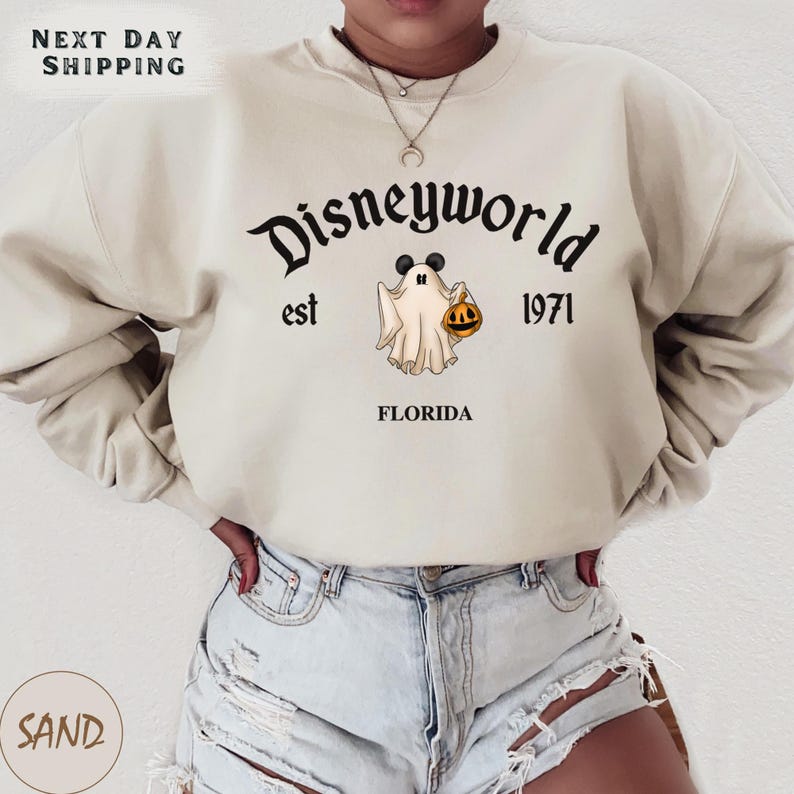 a woman wearing a sweatshirt with a ghost on it