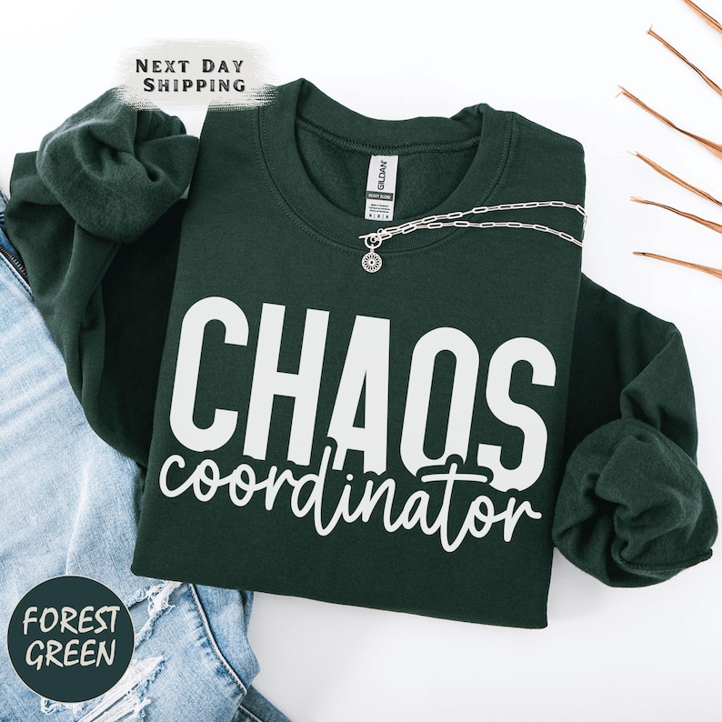 a t - shirt that says chaos coordination next to a pair of jeans