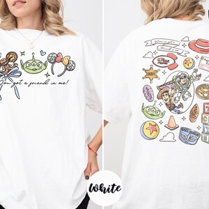 The image is a collage of two white t-shirts, each featuring a different cartoon character and various cartoon-related items.