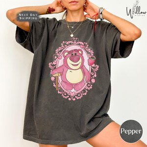 a woman wearing a t - shirt with a bear on it