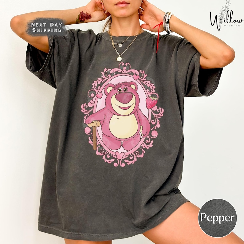 a woman wearing a t - shirt with a bear on it