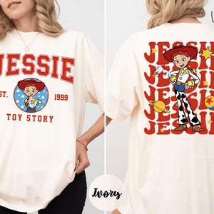 A woman wearing a white t-shirt with a graphic of a character from the Toy Story franchise.