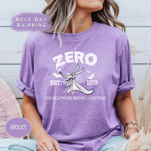 a woman wearing a purple shirt that says zero est est est est est est est