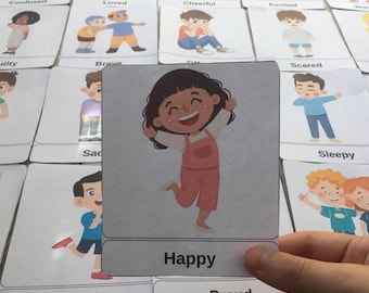 May include: A set of flashcards featuring illustrations of children expressing different emotions. The card shown features a girl with a big smile, jumping in the air, with the word "Happy" printed below the illustration.