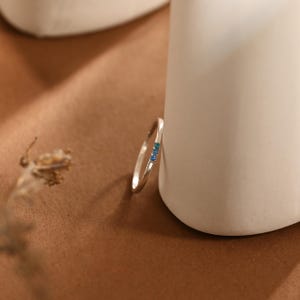 May include: A trio of ceramic mugs with a speckled, matte finish in cream, grey, and black. The mugs have a simple, modern design, suitable for coffee or tea.