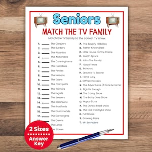 May include: A white paper with a red border features a matching game for seniors, matching TV families to their shows. The title reads "Seniors MATCH THE TV FAMILY." A blue pen rests on the wooden surface.