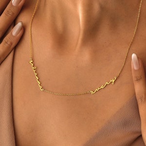 May include: A gold chain necklace with the word "every" written in cursive script.