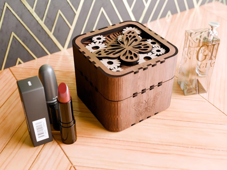 May include: A wooden box with a butterfly design and floral accents. The box is made of dark wood and has a light brown finish. The butterfly is cut out of the wood and has a natural wood colour. The flowers are also cut out of the wood and have a white finish.