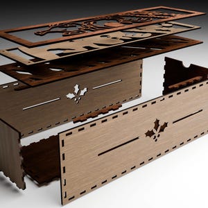 May include: Assembled wooden box with a Christmas theme. The box is made of several layers of laser-cut wood, with a holly leaf design and decorative cutouts. The box is unassembled, showing the individual pieces.